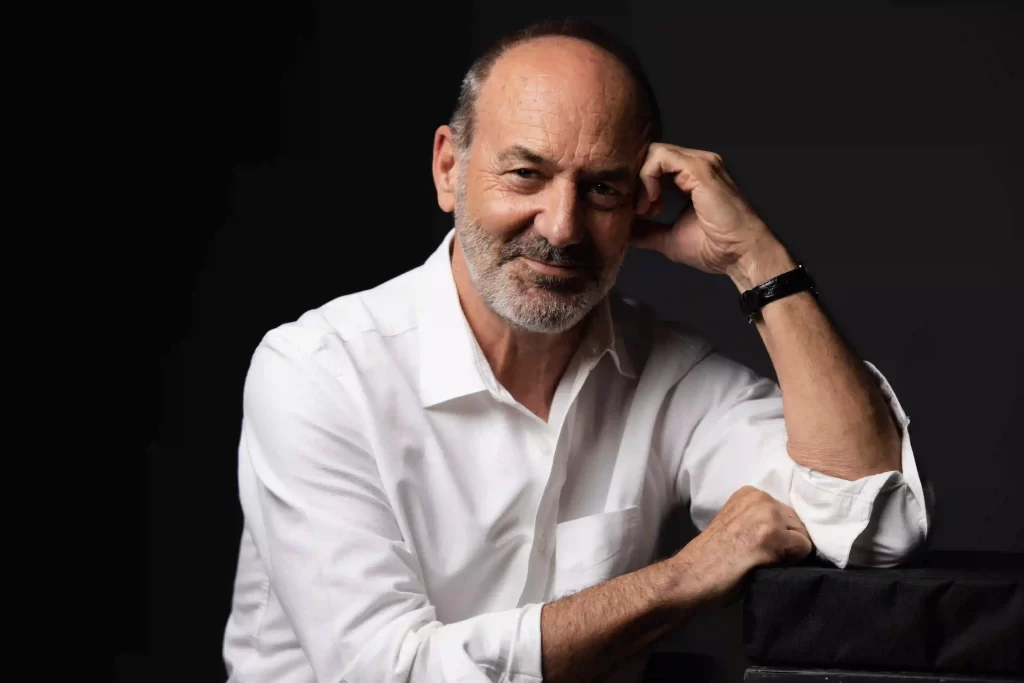 Professional headshot in casual white shirt on a dark background, photographed in Ocala.