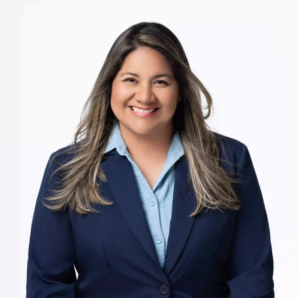 Professional headshot in navy blazer on a white background, photographed in Ocala.