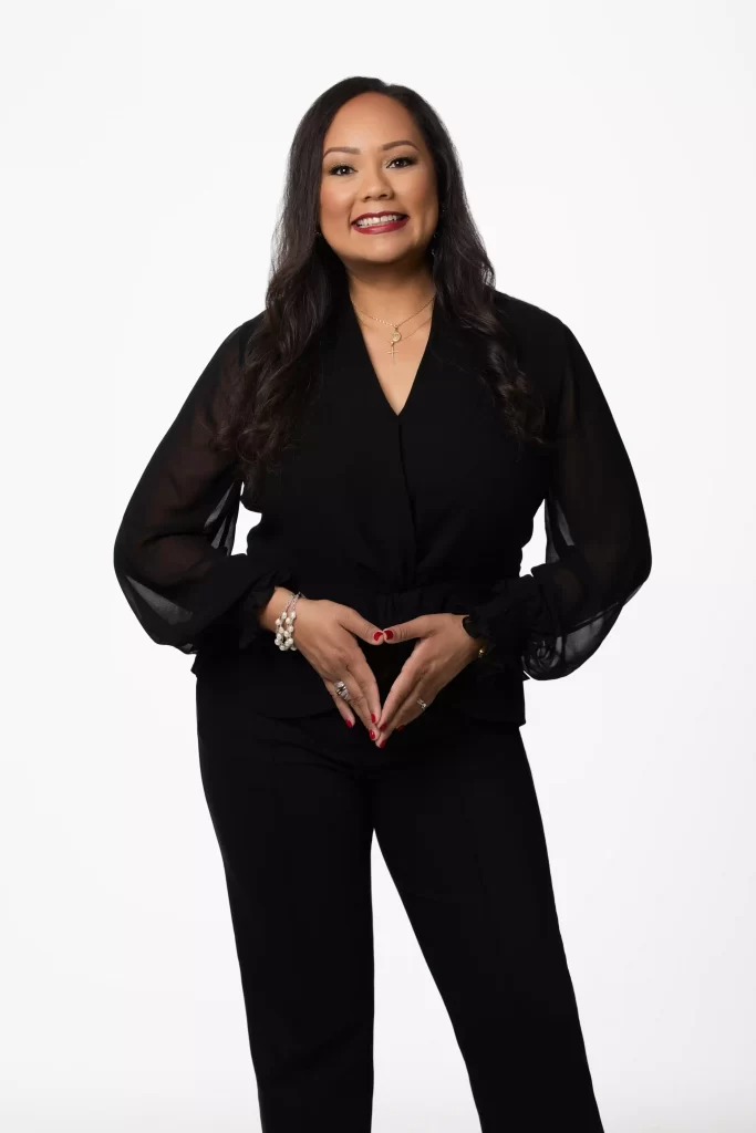 Professional portrait of woman in black outfit on a white background, photographed in Ocala.